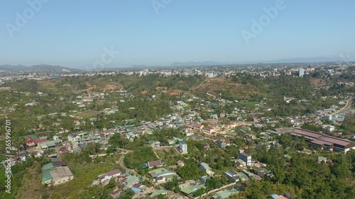 Wallpaper Mural AERIAL: Flying high over the outskirts of Bao Loc in Lam Dong Province in the Central Highlands region of Vietnam. Flying over houses, farms and streets heading away from the city. Torontodigital.ca