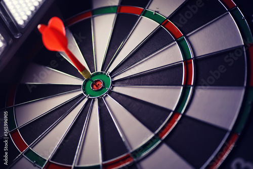 Darts. The dart for playing in the game board is stuck. Hit sector in darts. The concept of a successful strategy.