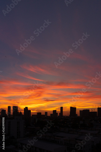 Silhouette of skyscraper city landscape background with beautiful sunset sky. © pjjaruwan