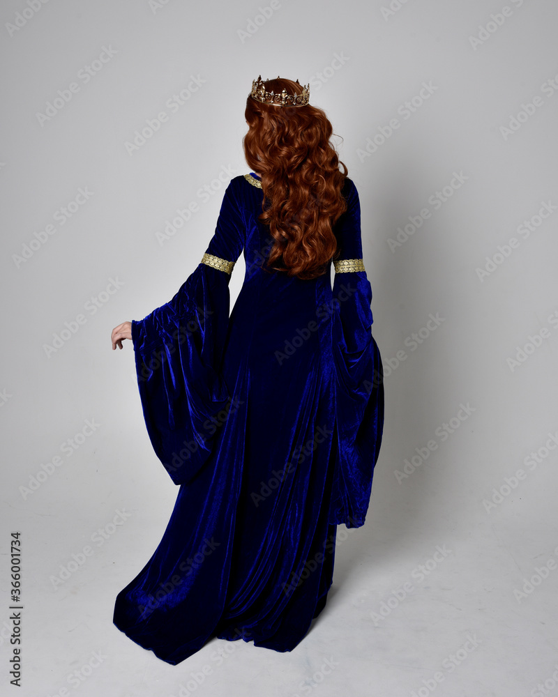 Full length portrait of girl wearing long blue velvet gown with golden ...