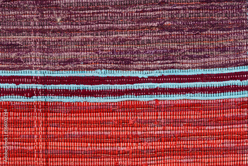 Multi Colored textile homespun rug. Folk nation creativity. Closeup. photo