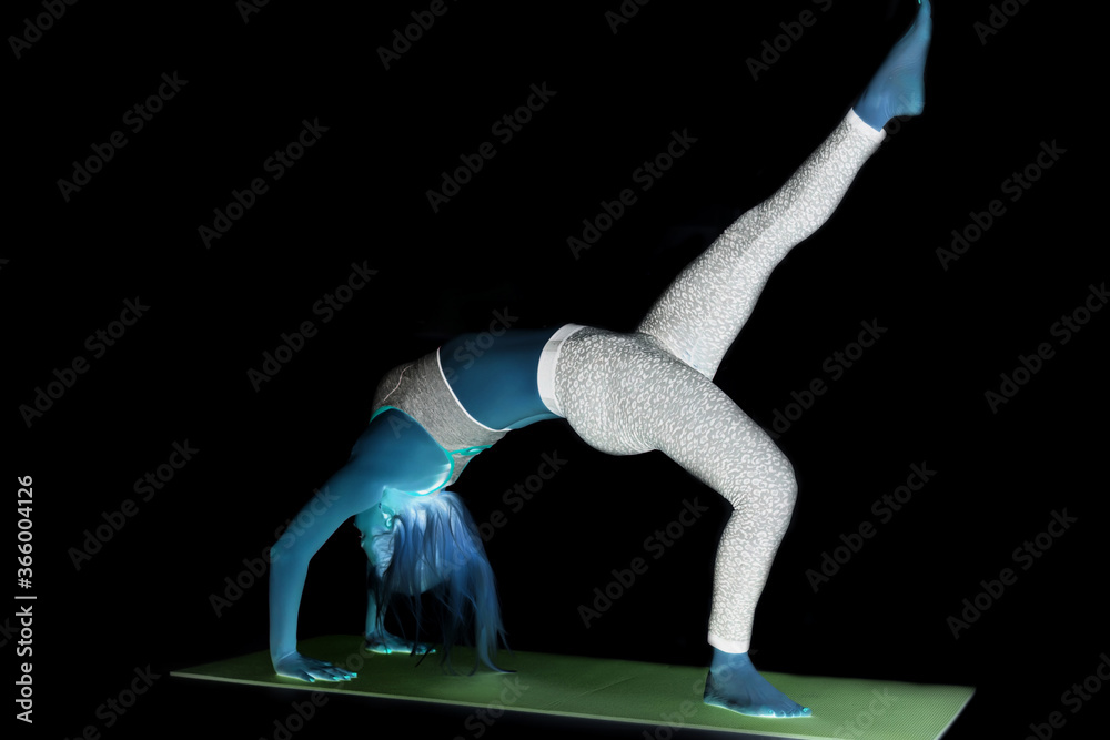 Fototapeta premium Close up image of middle eastern female in sports clothing relaxing after workout on grey background. Muscular female body with sweat. Image with copyspace for text