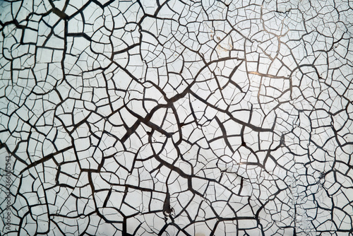 The surface is close to colour and cracks in white background.