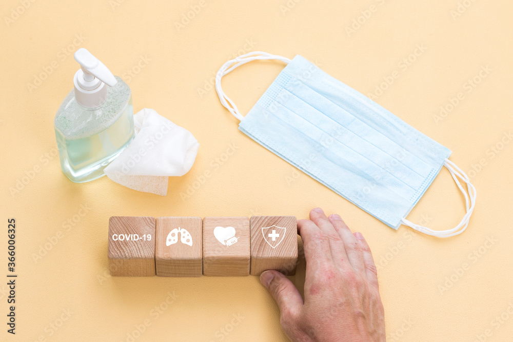 Doctor hand arranging wood block stacking with healthcare icon, insurance for your health concept from coronavirus. Doctor hand arranging wood block stacking with healthcare icon, insurance for your health concept from coronavirus.