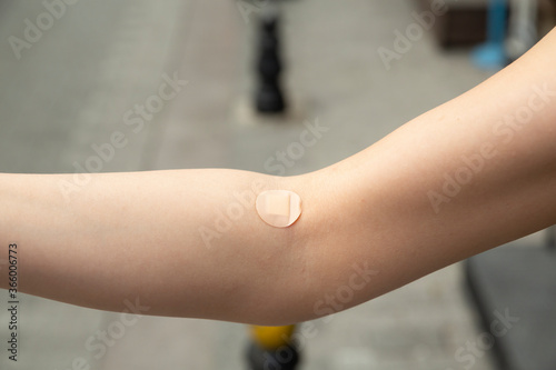 close up band-aid on arm