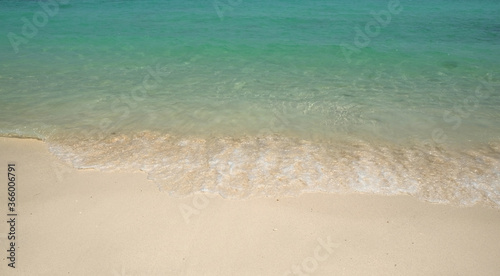Clear sea water and white sand beach background for decoration on summer holiday.