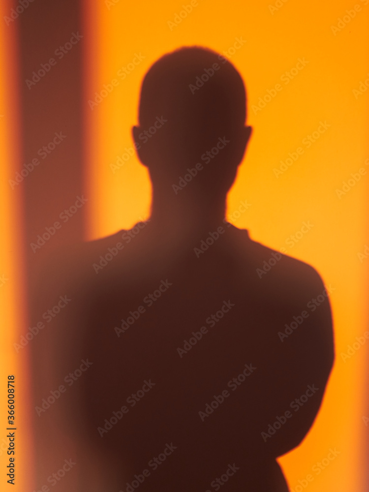 silhouette of a man on an orange background