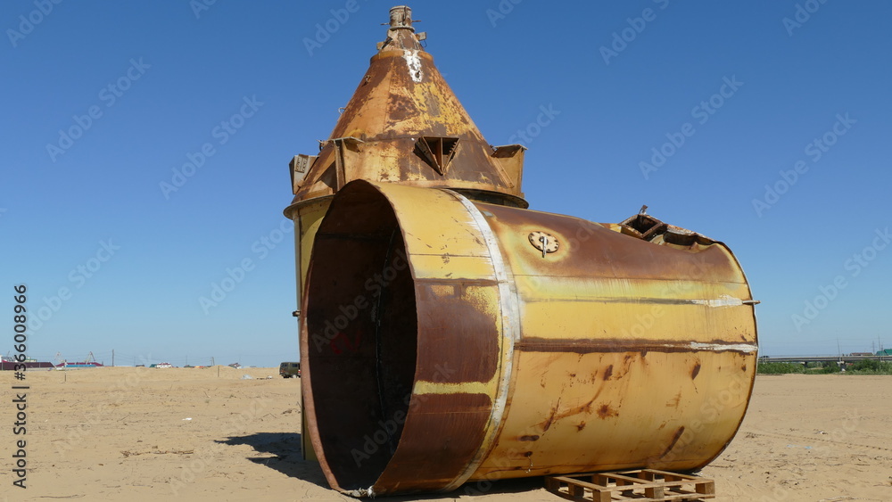 two large rusty old barrels.