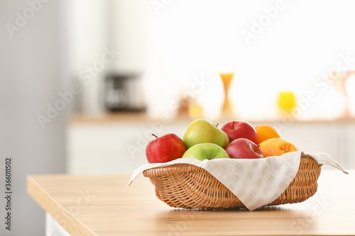 Fototapeta Naklejka Na Ścianę i Meble -  Basket with fresh fruits on table in kitchen