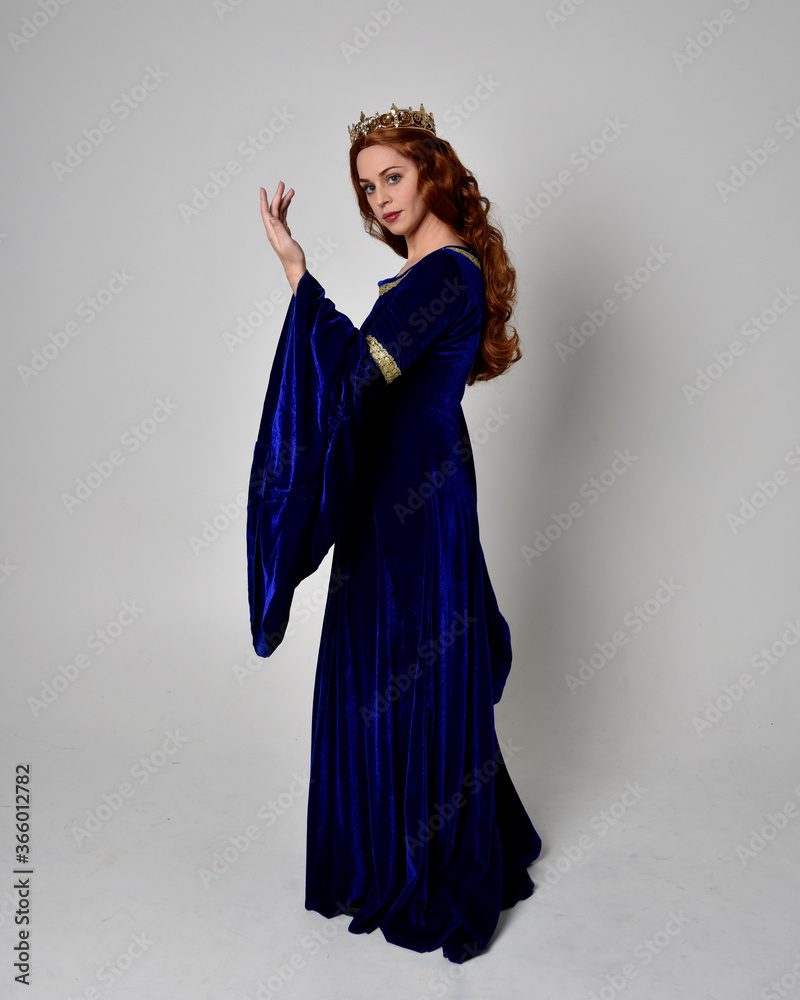 Full length portrait of girl wearing long blue velvet gown with golden ...