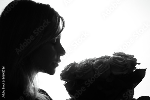 black and white photo of a girl with flowers on a white background