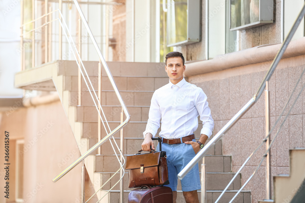 Fototapeta premium Young man with stylish bags near shop outdoors