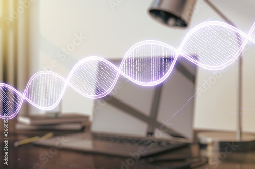 Double exposure of creative DNA hologram on laptop background. Bio Engineering and DNA Research concept