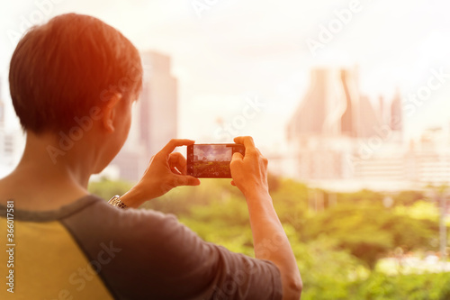 Tourist man taking photo in with smartphone
