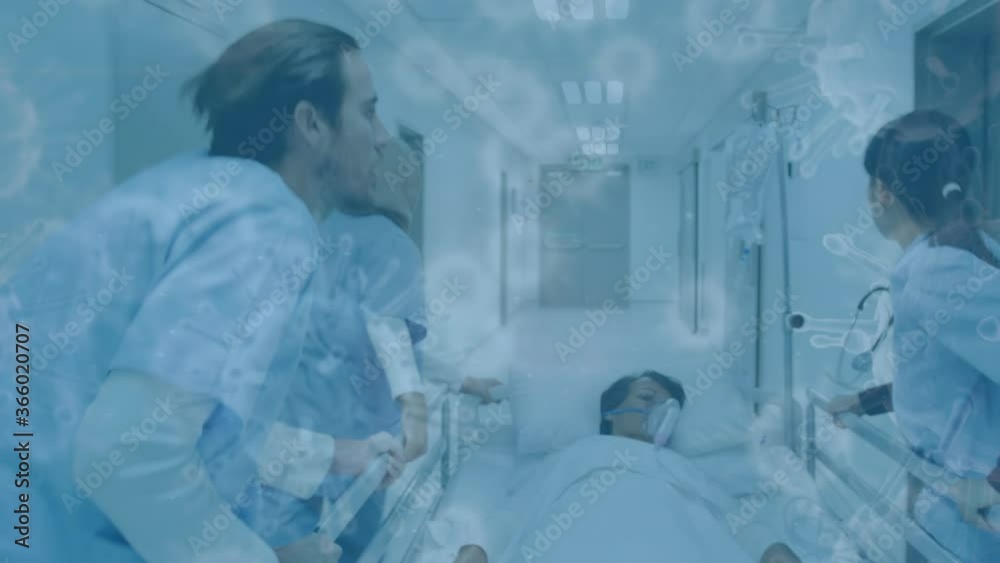 Covid-19 cells moving against doctors wheeling a bed in hospital Covid-19 cells moving against doctors wheeling a bed in hospital