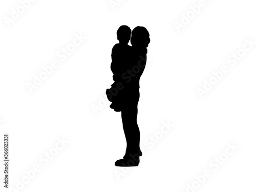 Silhouette of loving mom with baby in her arms