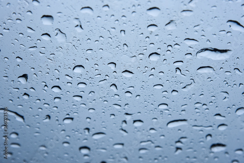 Closeup Raindrops on the glass of the car door