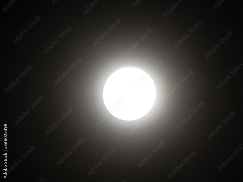 The moon shines in the night sky. The moon shines in the night sky.