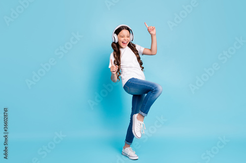Full length body size view of nice glad excited cheerful wavy-haired girl meloman listening stereo single dancing isolated on bright vivid shine vibrant blue teal turquoise color background