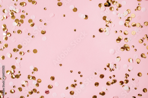 Background of colorful gold sparkling confetti with mockup frame on pink background. Festive holiday concept. Christmas. Wedding. Birthday. Mothers Day. Valentine's Day. Flat lay, top view