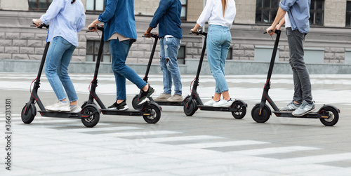 Friends having ride on motorized kick scooters