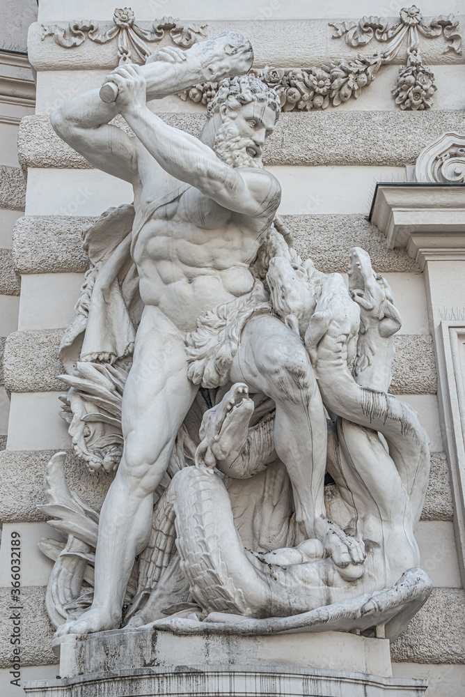 Fototapeta premium Statue of fight of Hercules with a club and Hydra, serpent like water monster from Classical Greek Mythology, Hofburg Palace, outdoor, Vienna, Austria, details, closeup