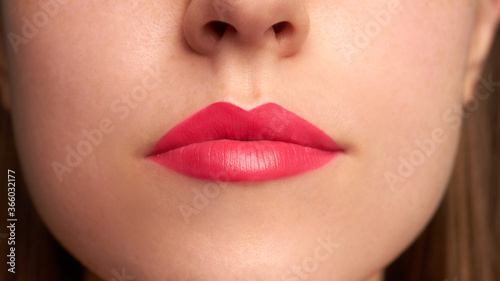 Close-up shot of woman lips with red lipstick. Beautiful perfect lips. Sexy mouth close up.