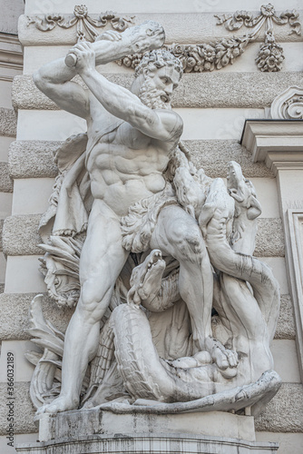 Statue of fight of Hercules with a club and Hydra, serpent like water monster from Classical Greek Mythology, Hofburg Palace, outdoor, Vienna, Austria, details, closeup