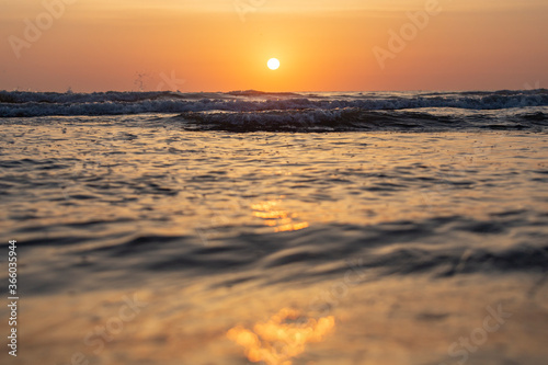 The sun rises over the mediterranean sea on a clear sky morning