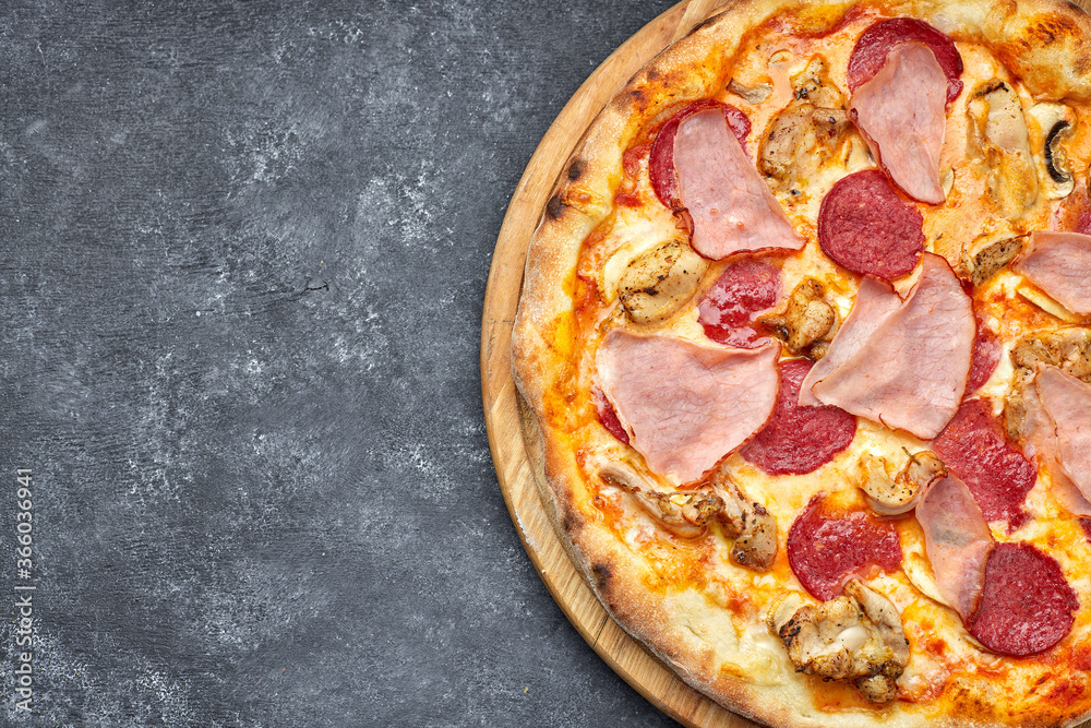 Pizza with meat, sausage, meat and mushrooms on a gray background with place for text. Pizza 4 meat
