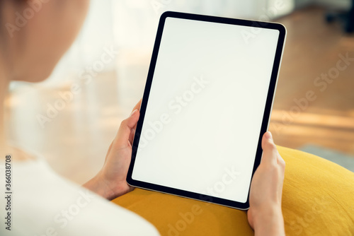 Hand holding digital tablet mockup of blank screen. Take your screen to put on advertising. photo