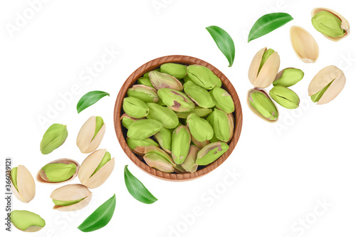 pistachio in wooden bowl isolated on white background with clipping path and full depth of field. Top view. Flat lay
