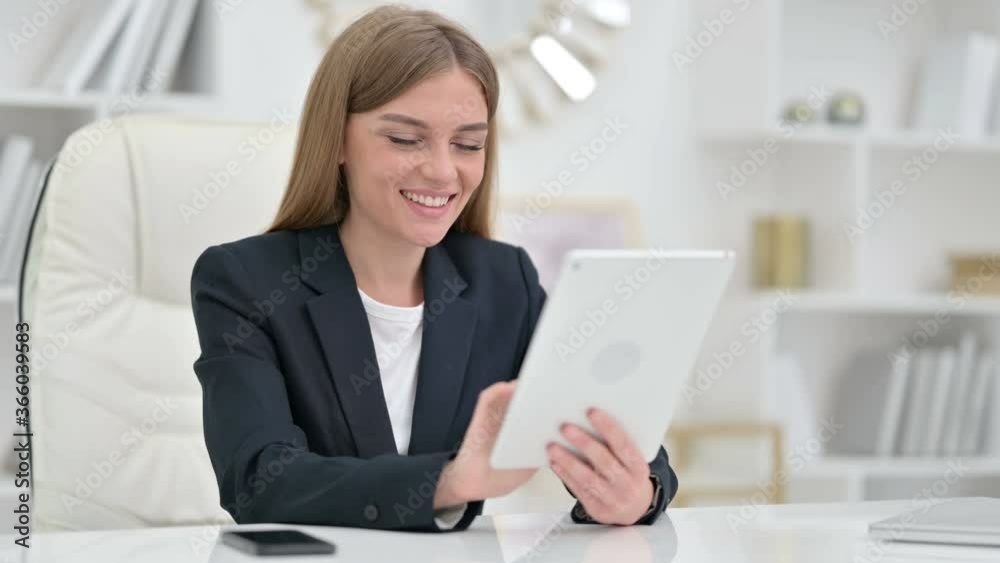 Excited Businesswoman Celebrating Success on Tablet Excited Businesswoman Celebrating Success on Tablet