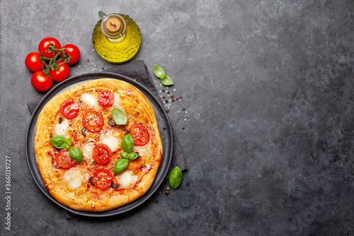 Tasty homemade pizza with tomatoes and basil