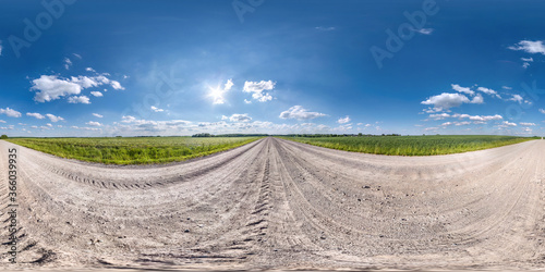 Full spherical seamless hdri panorama 360 degrees angle view on no traffic white sand gravel road among fields with clear sky in equirectangular projection, VR AR content