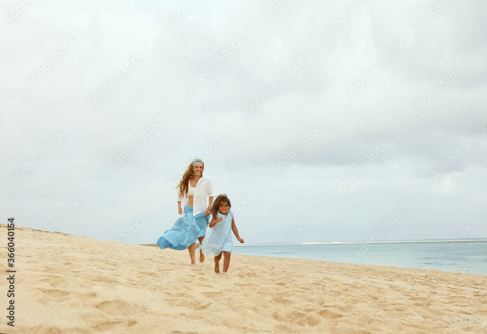 Kid And Mother On Beach. Little Girl And Young Woman In Fashion Maxi Dress Walking Along Coast. Mom And Daughter Having Fun On Summer Weekend. Summertime With Children For Happy Family.