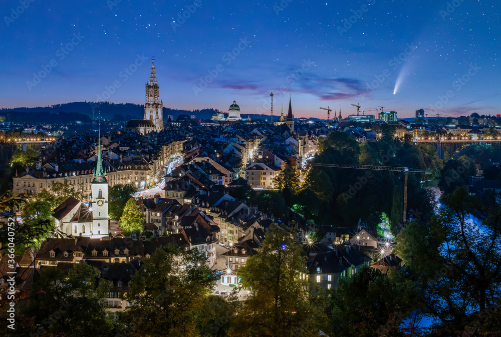 Comet C/2020 F3 Neowise in night sky over old town of Bern, Switzerland at twilight