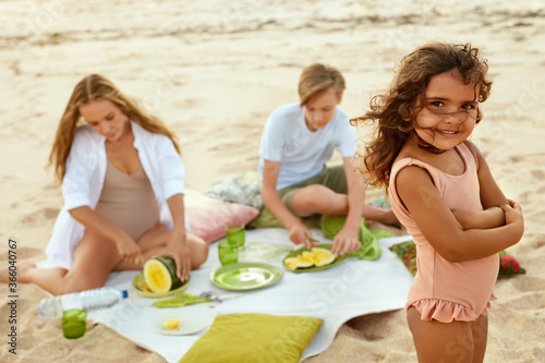 Summer. Family Picnic On Beach. Portrait Of Young Woman With Kids Enjoying Lunch At Tropical Ocean. Brother, Sister And Mother On Vacation Near Sea. Organic Fruit And Natural Vitamins.