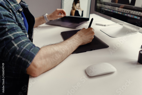 Graphic Designer working hands with interactive pen display, digital Drawing tablet and Pen. Concept of young people works mobile devices. photo