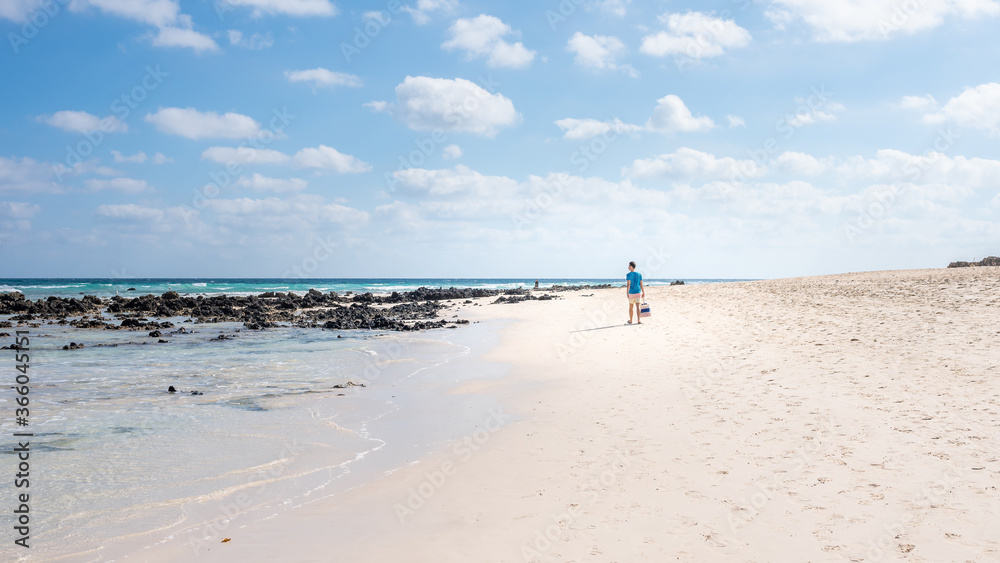 freedom concept, a man walks along the beach on the island of Fuerteventura Spain, Corralejo beach freedom concept, a man walks along the beach on the island of Fuerteventura Spain, Corralejo beach