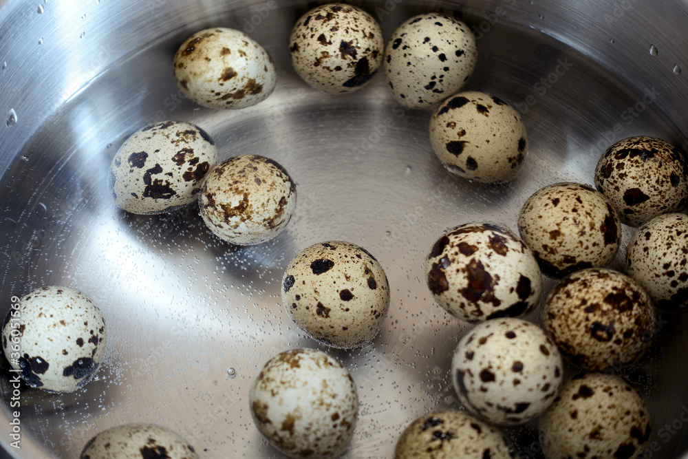 Boiling quail eggs on water. Cooking detail. 