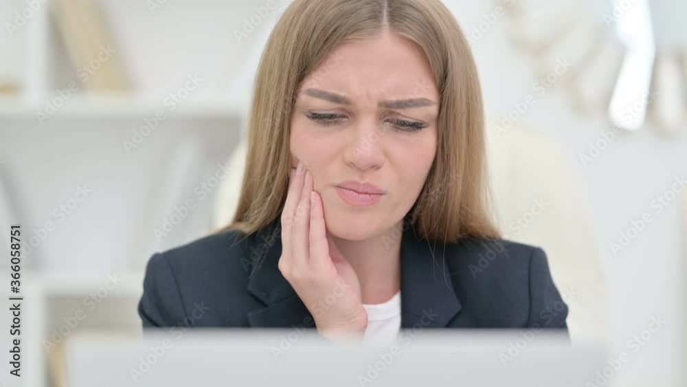 Young Businesswoman with Laptop having Toothache Young Businesswoman with Laptop having Toothache