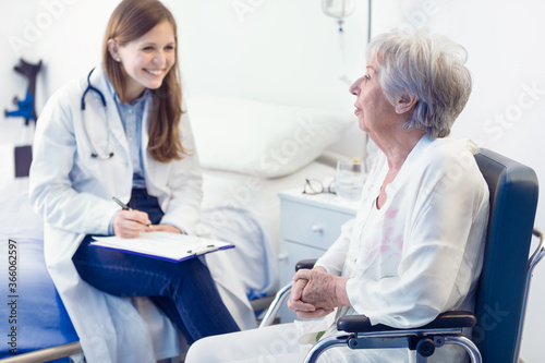 Nurse or doctor writing patient notes in a ward