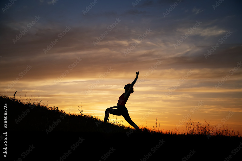 girl doing yoga in nature at sunset