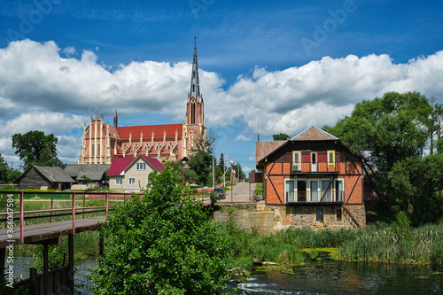 Retro water mill and old church of the Holy Trinity in Gerviaty on background, Grodno region, Belarus photo