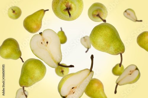 Falling whole and half green pears isolated on a color background with clipping path. Flying food, fruits. Top view