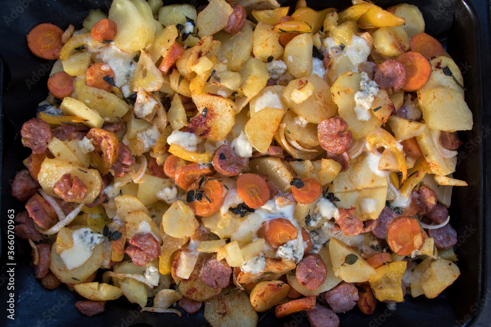 Homemade Hearty Breakfast Skillet with Eggs Potatoes and carrot on a metal plate Homemade Hearty Breakfast Skillet with Eggs Potatoes and carrot on a metal plate