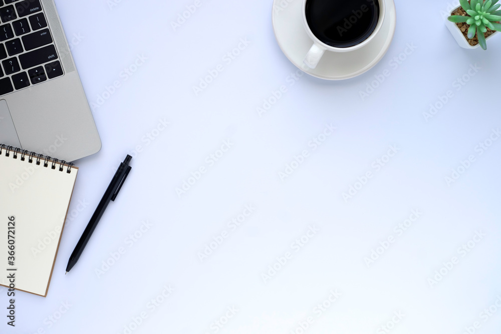 Top view above of White office desk table with laptop, notebook and coffee cup with equipment other office supplies. Top view above of White office desk table with laptop, notebook and coffee cup with equipment other office supplies.