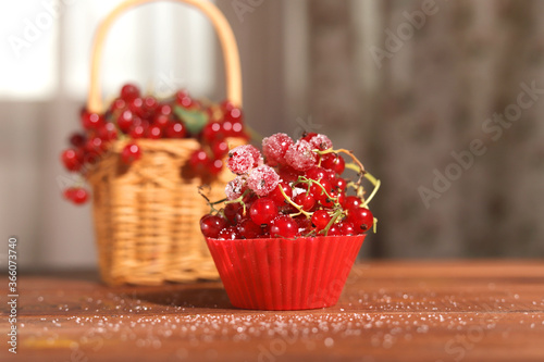 cupcake red currant on a background of currants in a basket