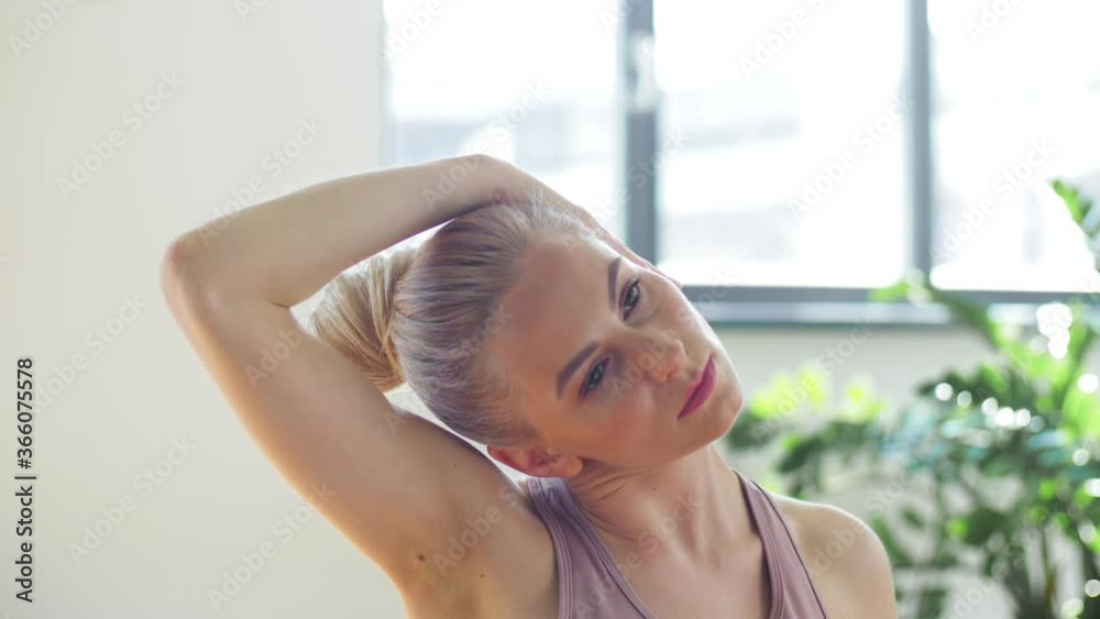 fitness, sport and healthy lifestyle concept - woman doing yoga exercises on mat in gym or studio